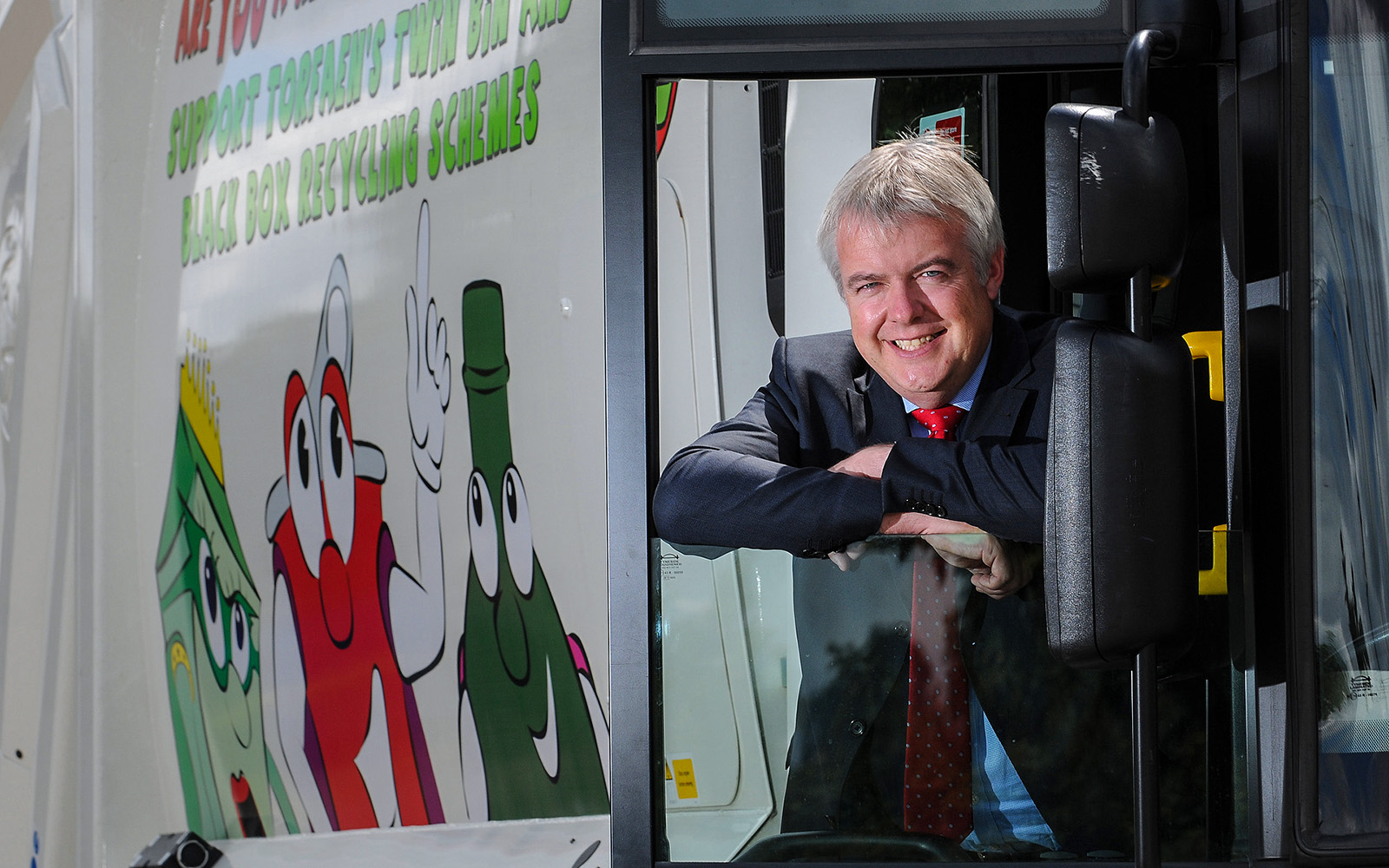 Wales First Minister Carwyn Jones travels by dustbin lorry as part of his tour of public services in Wales for Torfaen County Council
