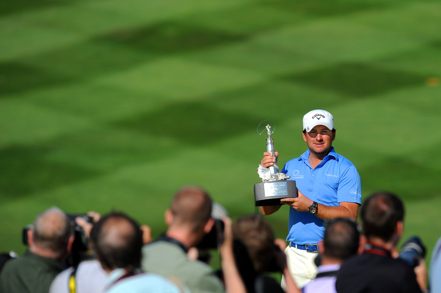 Graeme McDowell (NIR) poses for photographs on the 18th green after winning the Wales Open Golf, 2010